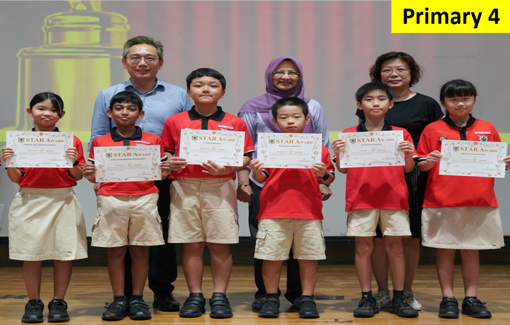 Six Primary 4 students in red uniforms hold Star Award certificates, flanked by two adult teachers on a stage.